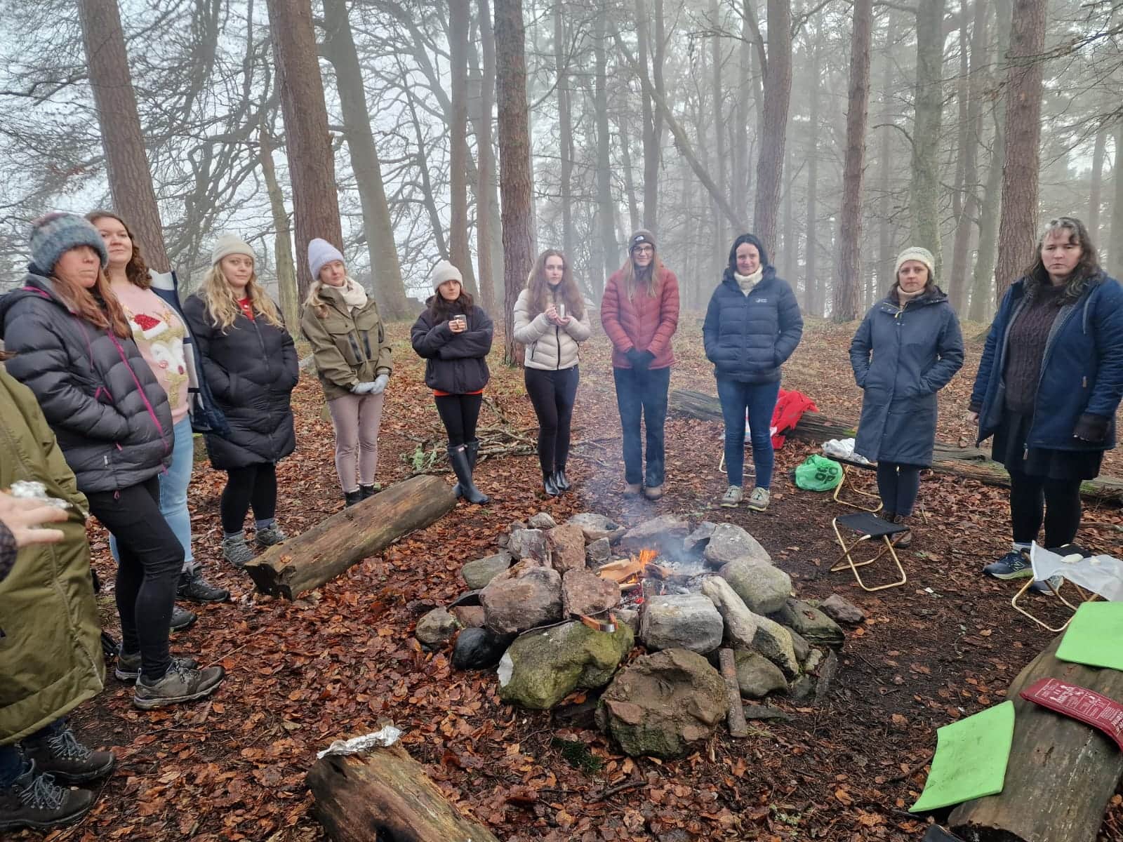 folk standing round a fire